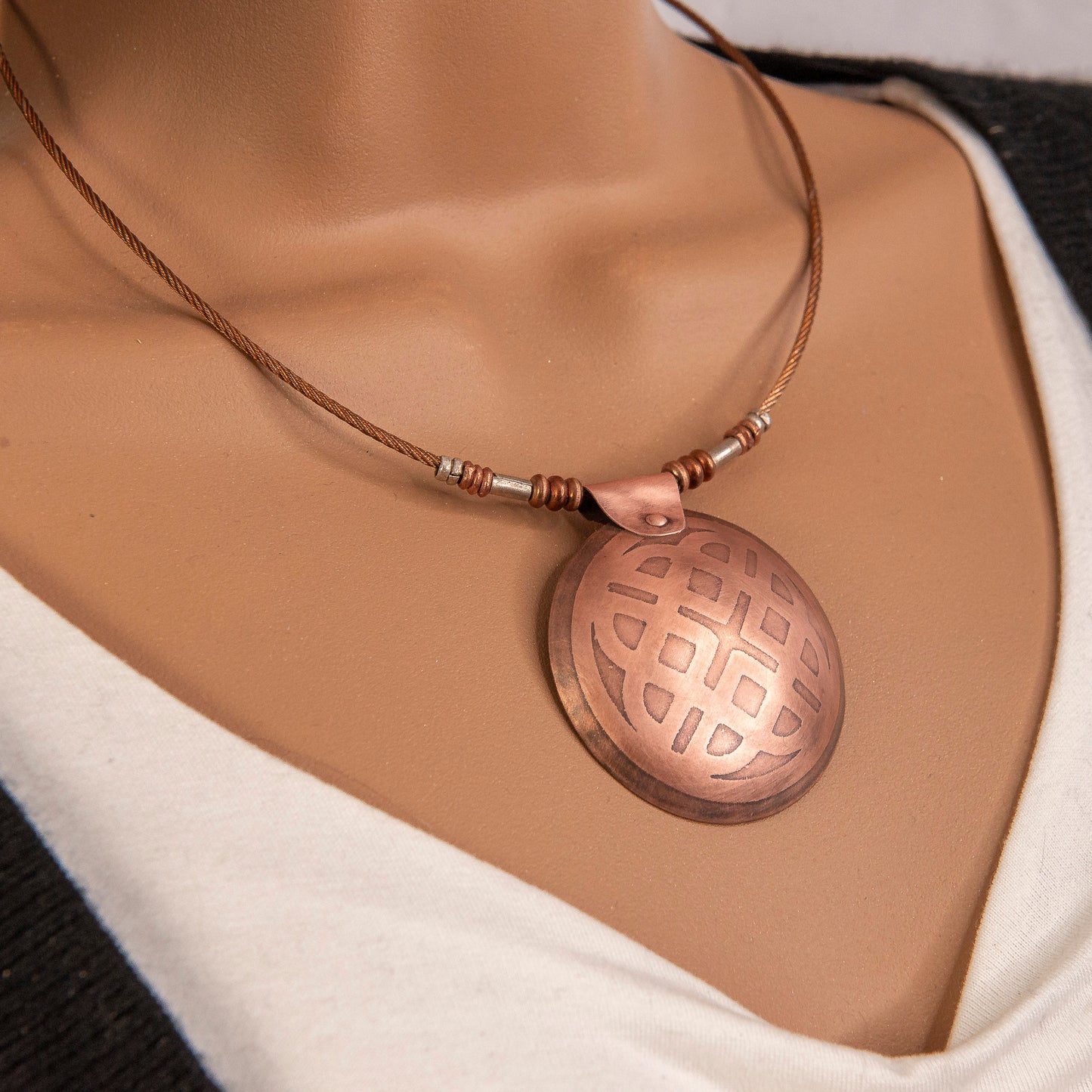 Etched Celtic geometric knot pendant.